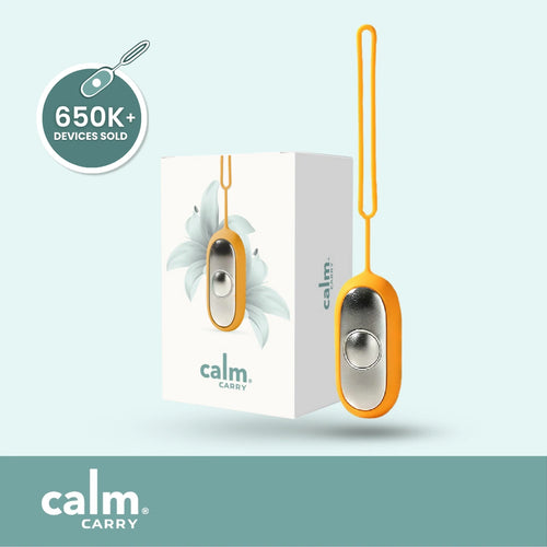 Orange CalmCarry device with packaging on a light blue background