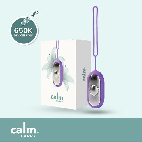 Purple CalmCarry device with packaging on a light blue background